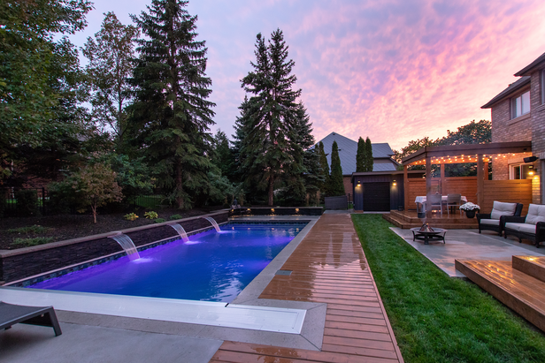 Backyard with pool and beautiful patio creating a pretty outdoor living space
